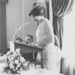 Barb Cook speaking at the podium during a 1950s dinner